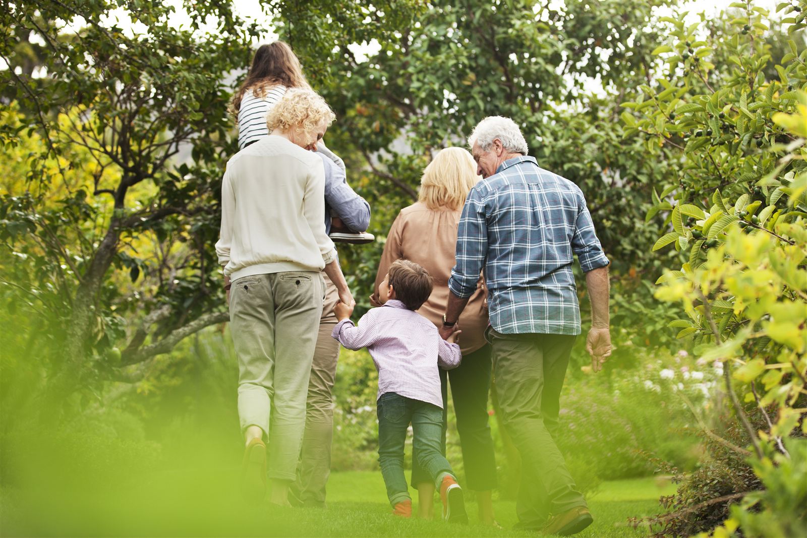A family walking together through a green garden